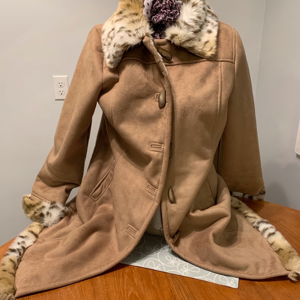 Beautiful faux sheepskin car coat with faux fur trim. Never worn.